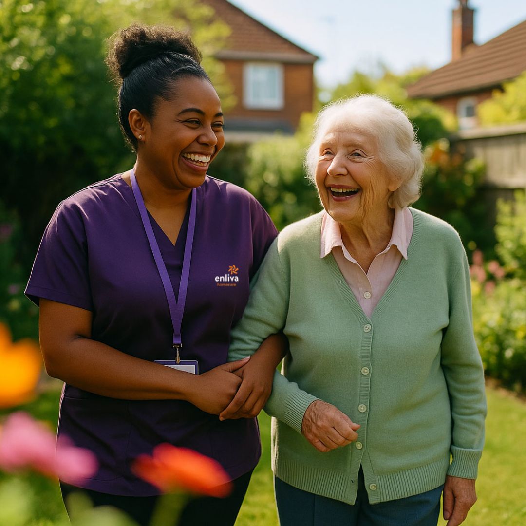 Enliva Homecare carer having a laugh and walking with a client in the garden