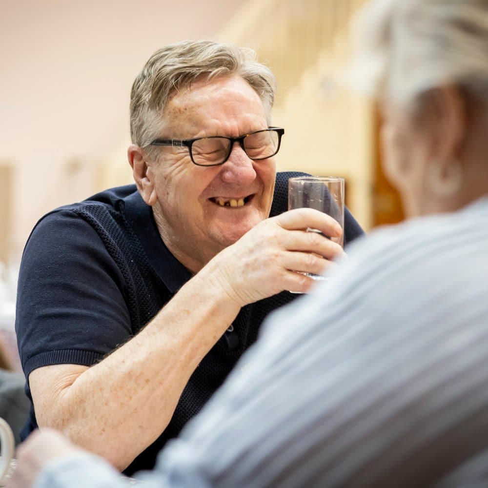 Two people engaged in conversation. Carer and client. brain injury care at home