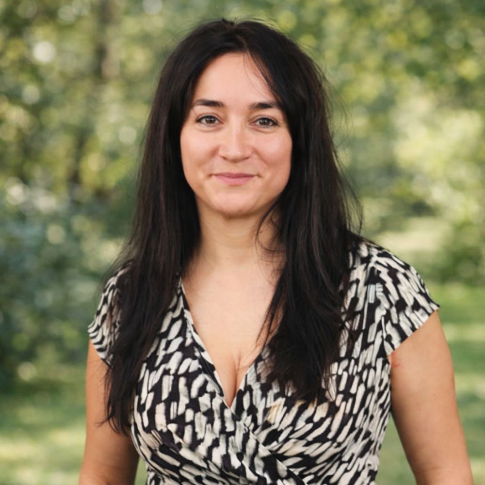 Woman in patterned dress outdoors Corina Toma Enliva Homecare Reading Manager